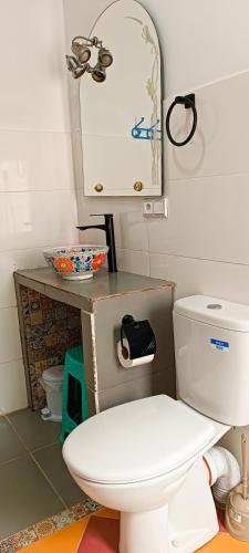 a bathroom with a white toilet and a sink at Riad SULTANA lateral seaview in Saidia 