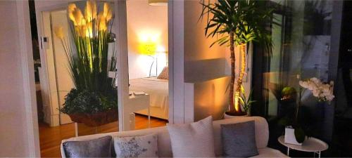 a living room with a white couch and some plants at Lux -Luxury Sea and Mountains View Apartment-NEW in Koper