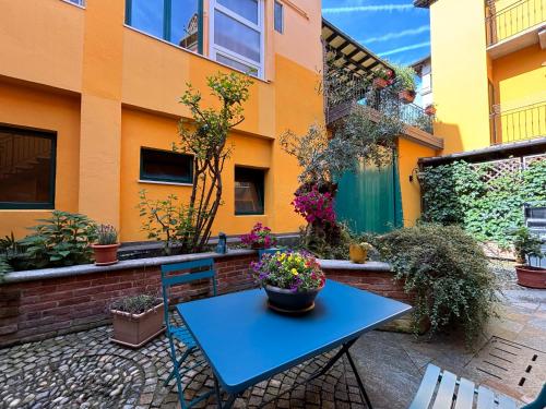 a blue table and chairs in front of a building at La finestra dei Batù by Alterego in Villanova dʼAsti