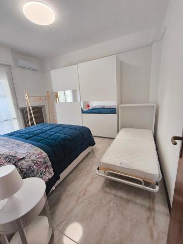 a bedroom with a bed and a table and a chair at Appartamento AZZURRO in Pesaro