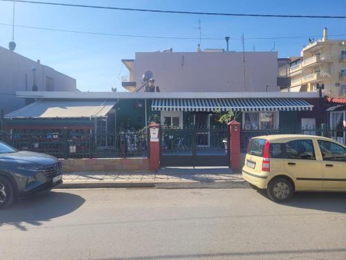 two cars parked in a parking lot in front of a store at Alex Home 1 in Alexandroupoli