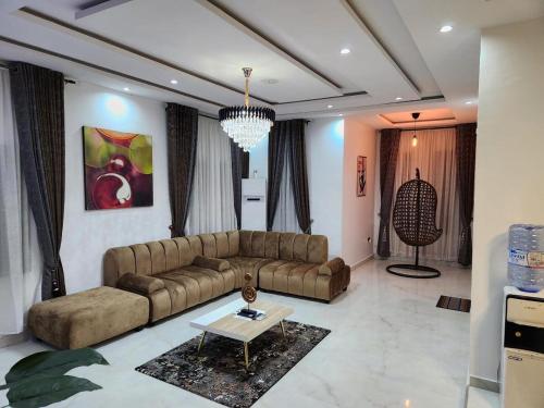 a living room with a couch and a table at De- Fmoapartments in Lagos