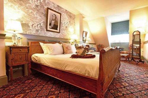 a bedroom with a large bed in a room at The Duchess of Cornwall in Dorchester