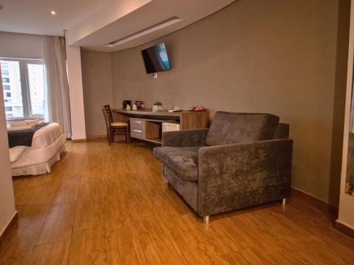 a living room with a couch and a chair at Continental Inn in Foz do Iguaçu