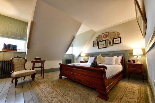 a bedroom with a bed and a chair at The Duchess of Cornwall in Dorchester