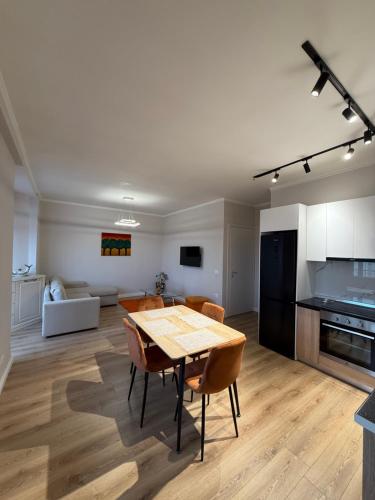 a kitchen and living room with a table and chairs at classy apartment Lea 3 in Durrës