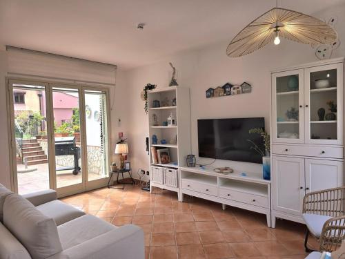 a living room with a tv and a couch at Villa Aloe di Calanica Cefalù in Cefalù