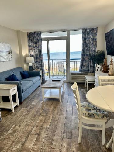 a living room with a couch and a table at Boardwalk Beach Resort in Myrtle Beach