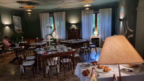 a dining room with tables and chairs with food on them at Albergo Trieste Boves - Ricetto Suite in Boves