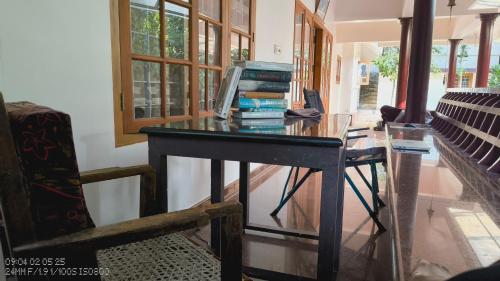 a desk with a computer on it in a room at The Mangosteen Homestay in Kodanad