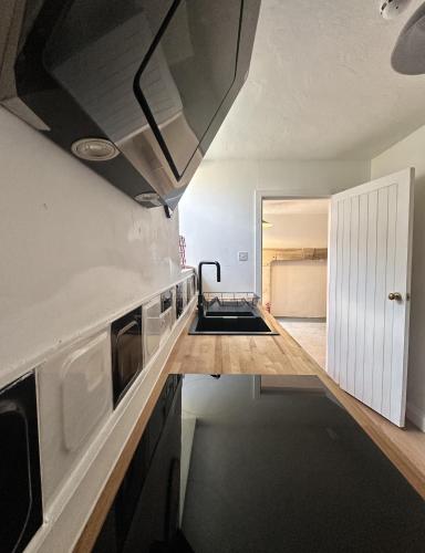 a kitchen with a sink and a stove top oven at Hotwells Clifton Apartment in Bristol