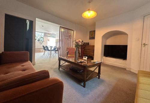 a living room with a couch and a table at Hotwells Clifton Apartment in Bristol