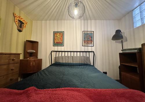 a bedroom with a bed and a dresser at Hotwells Clifton Apartment in Bristol