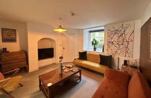 a living room with a couch and a table at Hotwells Clifton Apartment in Bristol