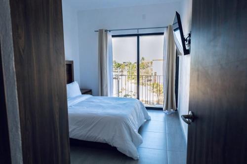 a bedroom with a bed and a large window at Casa Ivanna Vallarta in Puerto Vallarta