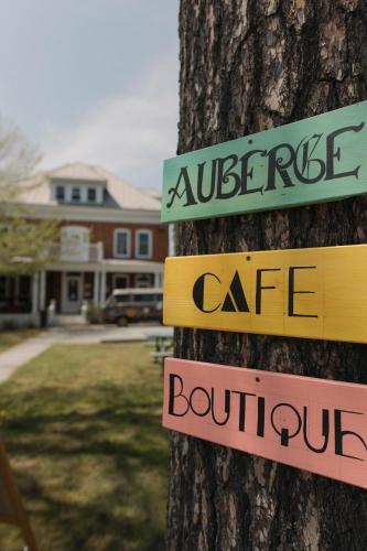 a tree with signs on the side of it at Auberge de Jeunesse Magog-Orford Hostel in Magog-Orford