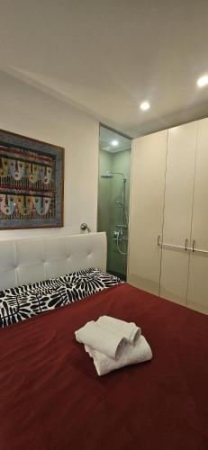 a bedroom with a white bed and a shower at Il Grattacielo Luxury Home - Pinerolo Center - Confort and Beautiful View in Pinerolo