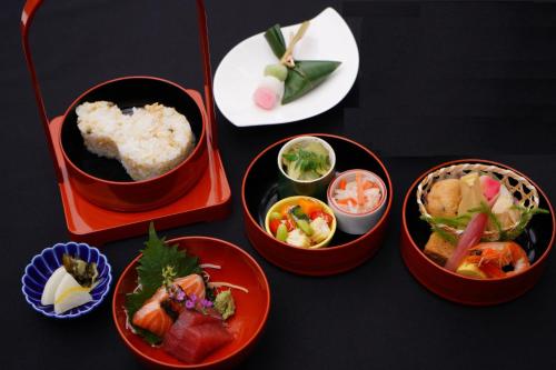 four bowls filled with different types of food on a table at Homm Stay Nagi Arashiyama Kyoto By Banyan Group in Kyoto