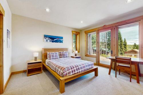 a bedroom with a bed and a desk and a window at Extraordinary Tahoe-Donner Modern Mountain Home in Truckee
