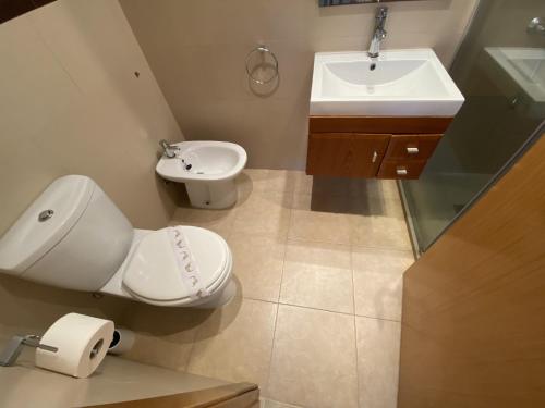a bathroom with a toilet and a sink at Apartamentos Marina Park in Oropesa del Mar