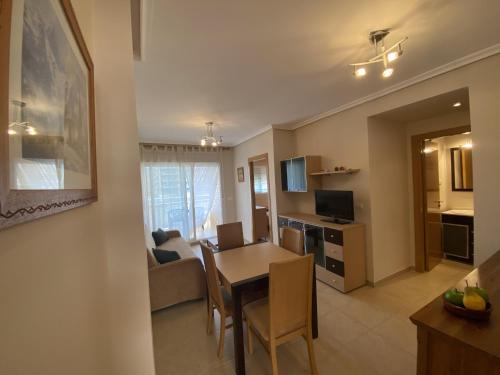 a living room with a table and a dining room at Apartamentos Marina Park in Oropesa del Mar