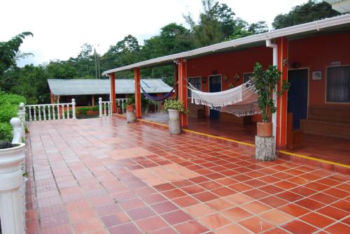 a patio with umbrellas and a patio table at Finca Las Mercedes in Cumaca