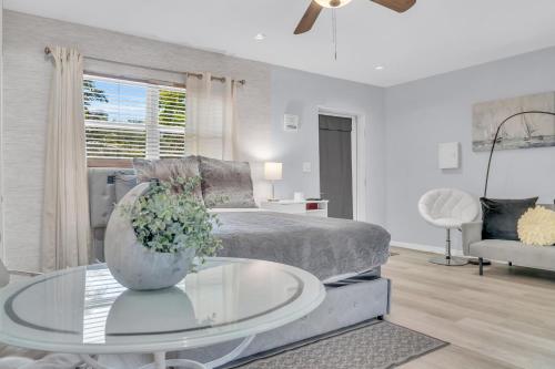 a living room with a bed and a glass table at The Hidden Gem - Private Cottage in Biscayne Park in North Miami