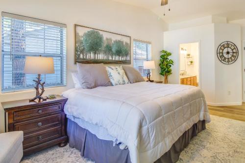 a bedroom with a bed and a dresser and windows at Walk to City Park Family-Friendly Show Low Home in Show Low