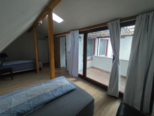 a bedroom with a bed and a large window at Ferienwohnung im Herzen des Lausitzer Seenlandes in Hoyerswerda