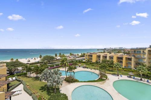 an aerial view of a resort with two pools and the beach at Beachfront - Royal Penthouse 3BR condo - BC352 in Palm-Eagle Beach