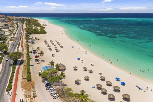 an aerial view of a beach with umbrellas and the ocean at Beachfront - Royal Penthouse 3BR condo - BC352 in Palm-Eagle Beach