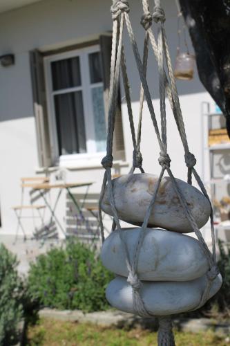 a hanging bag of onions in front of a house at Levanda Home in Taktikoúpolis