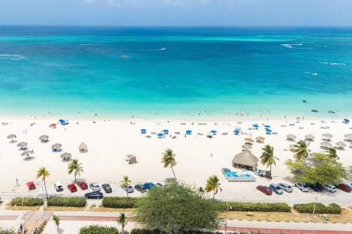 an aerial view of a beach with umbrellas and the ocean at Eagle Beach-Best value-Island View 1BR condo-R362 in Palm-Eagle Beach