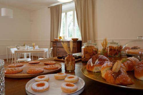 a table with several plates of donuts on it at Tenuta Maison Angelina in Formia