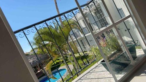 a window view of a resort with a swimming pool at Casa con jardín y piscina ideal para el fin de semana in Temimilcingo