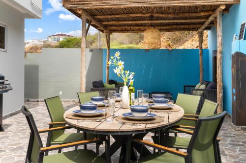 a table and chairs in the patio of a house at Casa Tortuga in Grote Berg