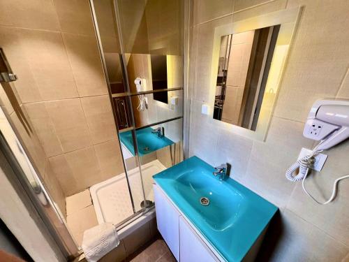 a bathroom with a blue sink and a shower at MT Boutique Suites y Apartamentos - Adults Only - in Mataró
