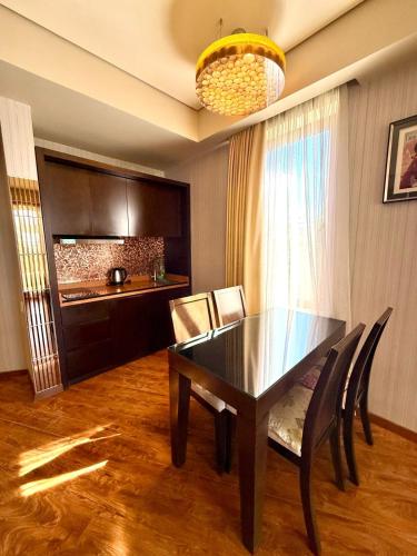 a dining room with a black table and chairs at Dreamland oasis in Chakvi in Chakvi