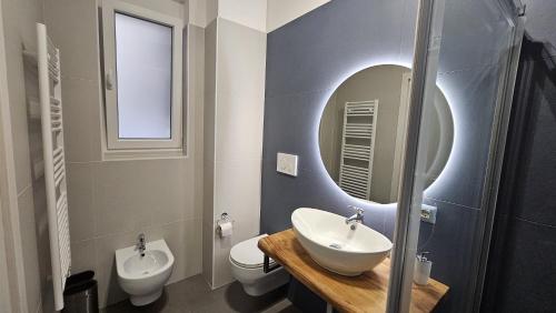 a bathroom with a sink and a toilet and a mirror at 41 Parallelo - Comfort rooms in Bari