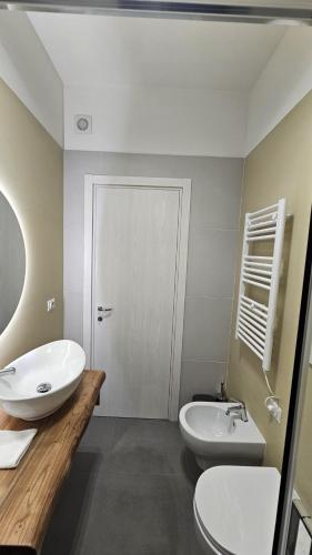 a bathroom with a white sink and a toilet at 41 Parallelo - Comfort rooms in Bari