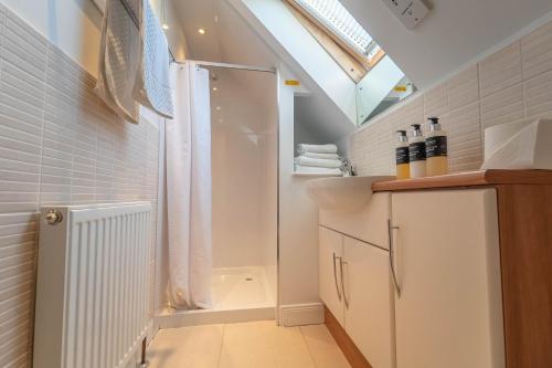 a bathroom with a shower and a sink at Tigh na Drochaid, Glen Nevis - Entire Apartment in Fort William