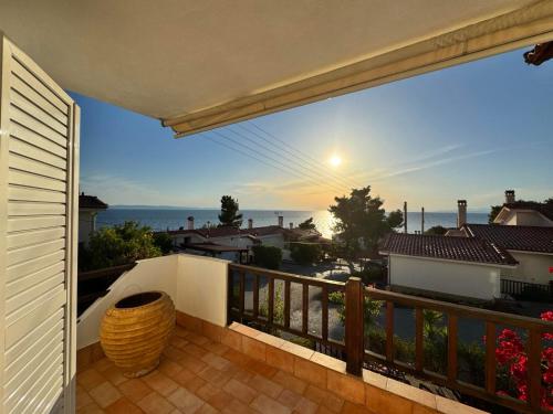 a balcony with a view of the ocean at Seafront Private Apartment in Neos Marmaras