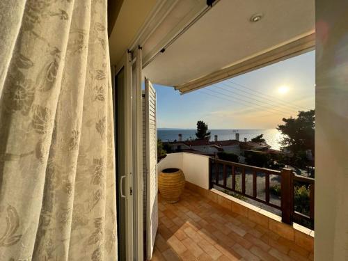 a balcony with a view of the ocean at Seafront Private Apartment in Neos Marmaras