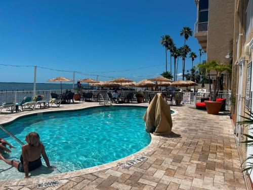 a couple of people sitting in a swimming pool at Beso Del Sol Resort in Dunedin