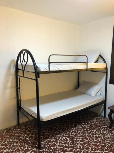 Postel nebo postele na pokoji v ubytování Hostal Casa Veracruz