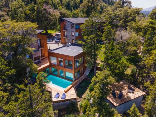 an aerial view of a house with a swimming pool at Suites Del Lago Peñon de Arelauquen, Bariloche in San Carlos de Bariloche