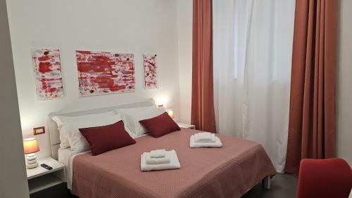 a bedroom with a bed with two towels on it at 41 Parallelo - Comfort rooms in Bari
