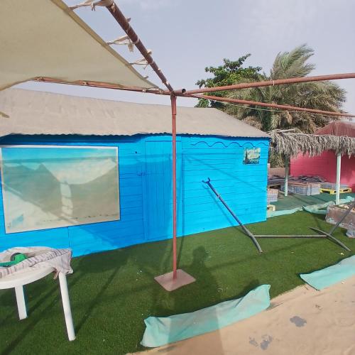 a blue shack with a swing at Auberge Triskell in Nouakchott