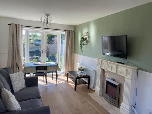a living room with a fireplace and a tv on the wall at Easedale - 2 Bdrm Sleeps 4 Ideal for Contractors in Gateshead