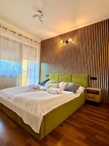 a bedroom with a large bed and a window at Apartament Leśny z kominkiem - Viva Pod Giewontem Apartamenty in Zakopane